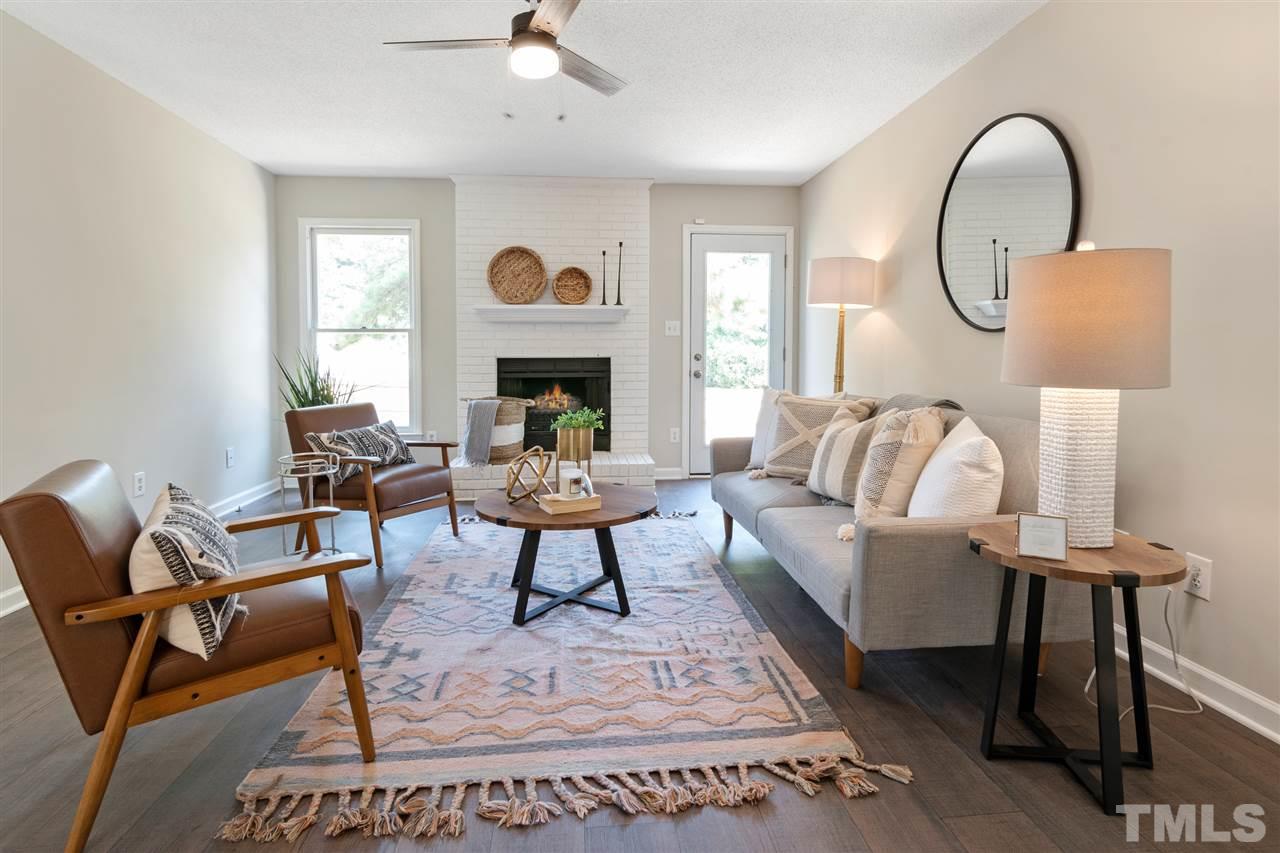 3324 Castlegate Drive Raleigh, NC 27616 - Photo 6 of 26 a living room with furniture a table and a large window