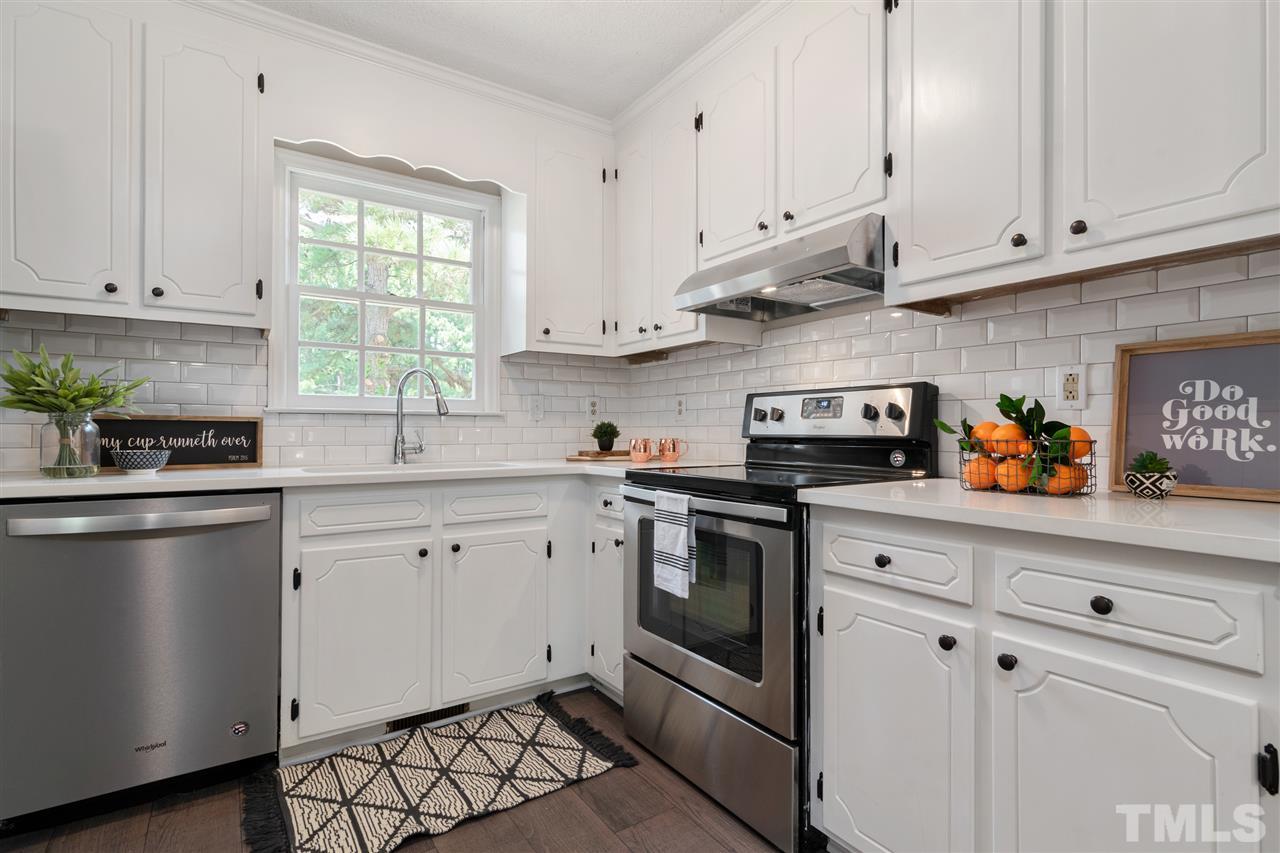 3324 Castlegate Drive Raleigh, NC 27616 - Photo 9 of 26 a kitchen with stainless steel appliances granite countertop white cabinets a sink and dishwasher