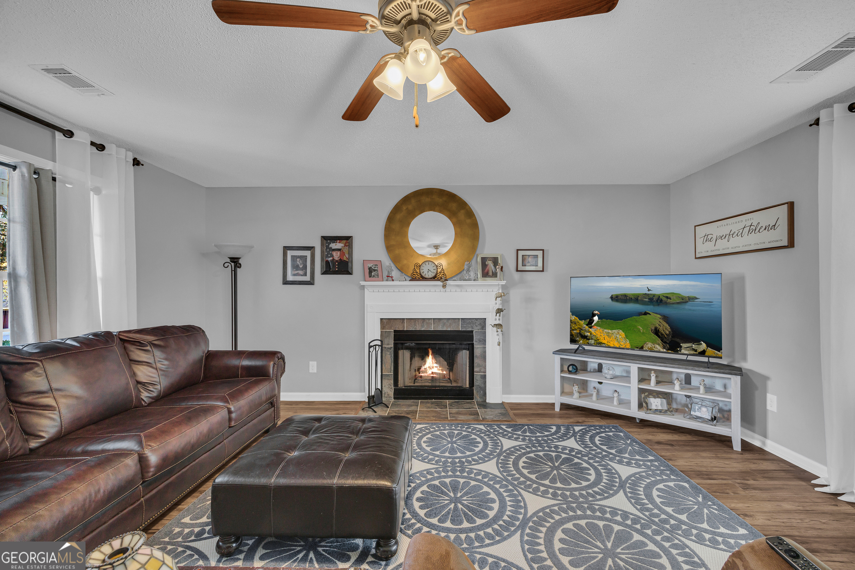 259 Watson Drive Hull, GA 30646 - Photo 22 of 47 a living room with furniture a fireplace and a flat screen tv