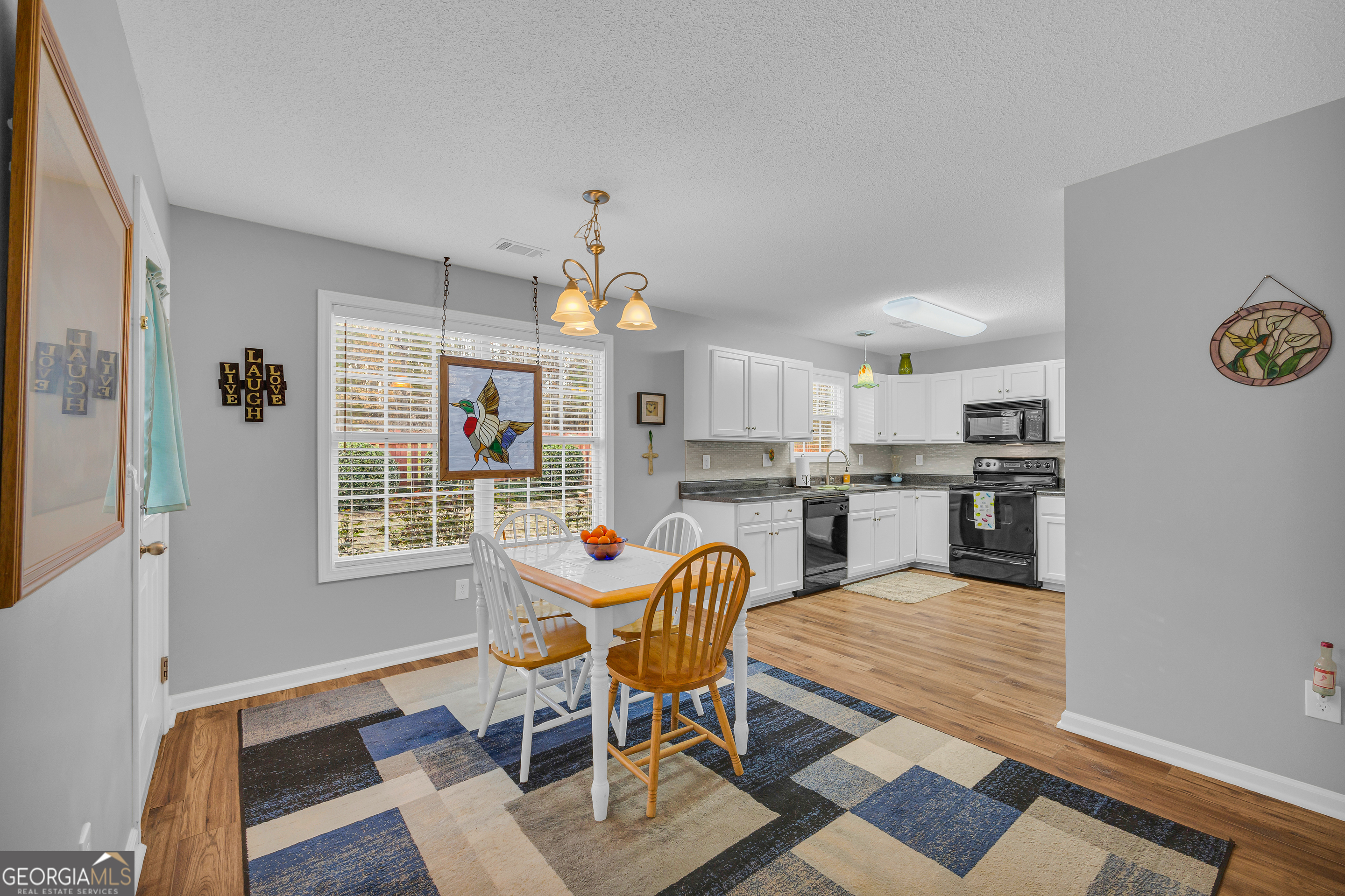 259 Watson Drive Hull, GA 30646 - Photo 25 of 47 a view of a dining room with furniture and chandelier