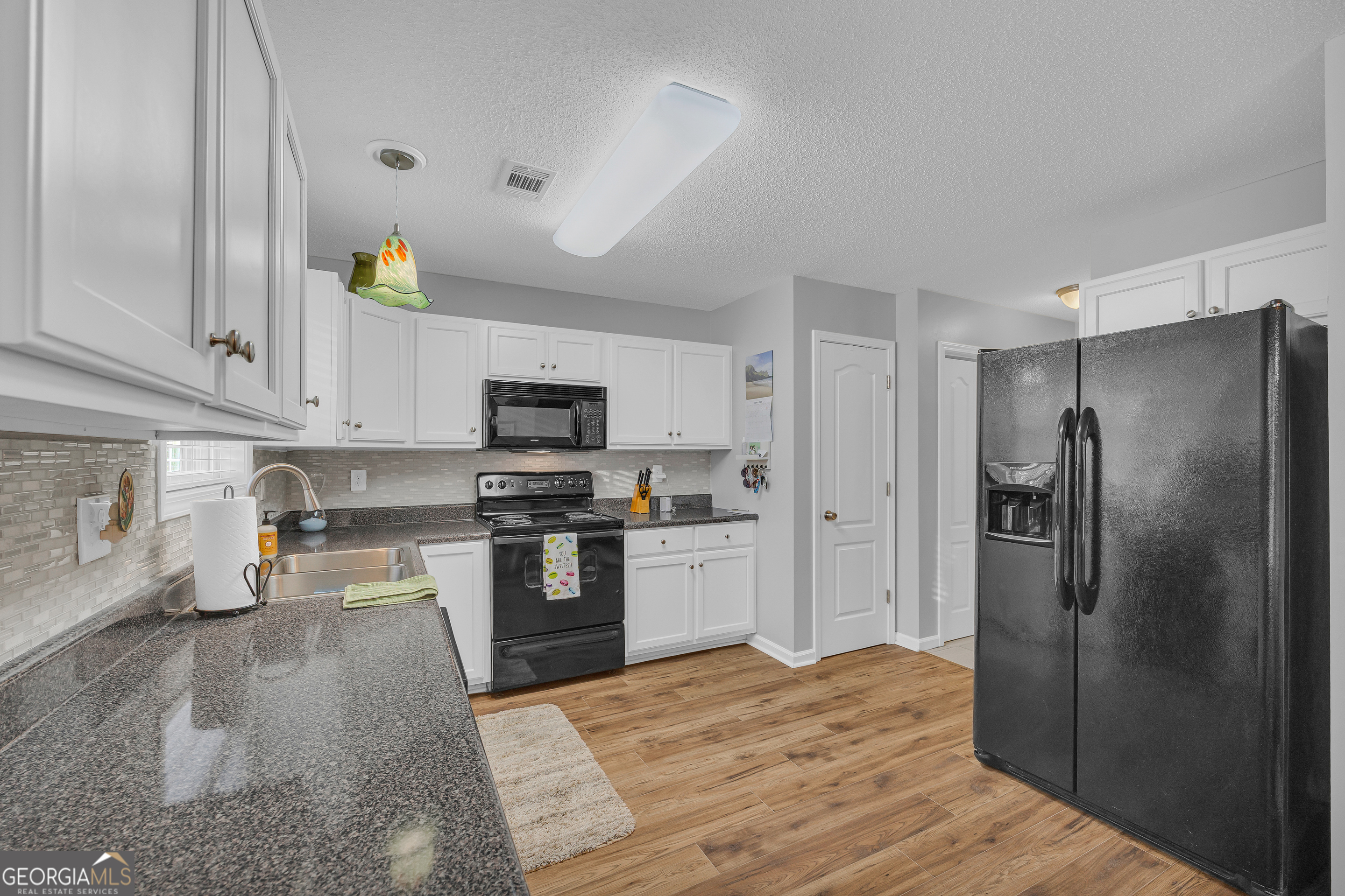 259 Watson Drive Hull, GA 30646 - Photo 30 of 47 a kitchen with stainless steel appliances granite countertop a refrigerator a stove and a sink