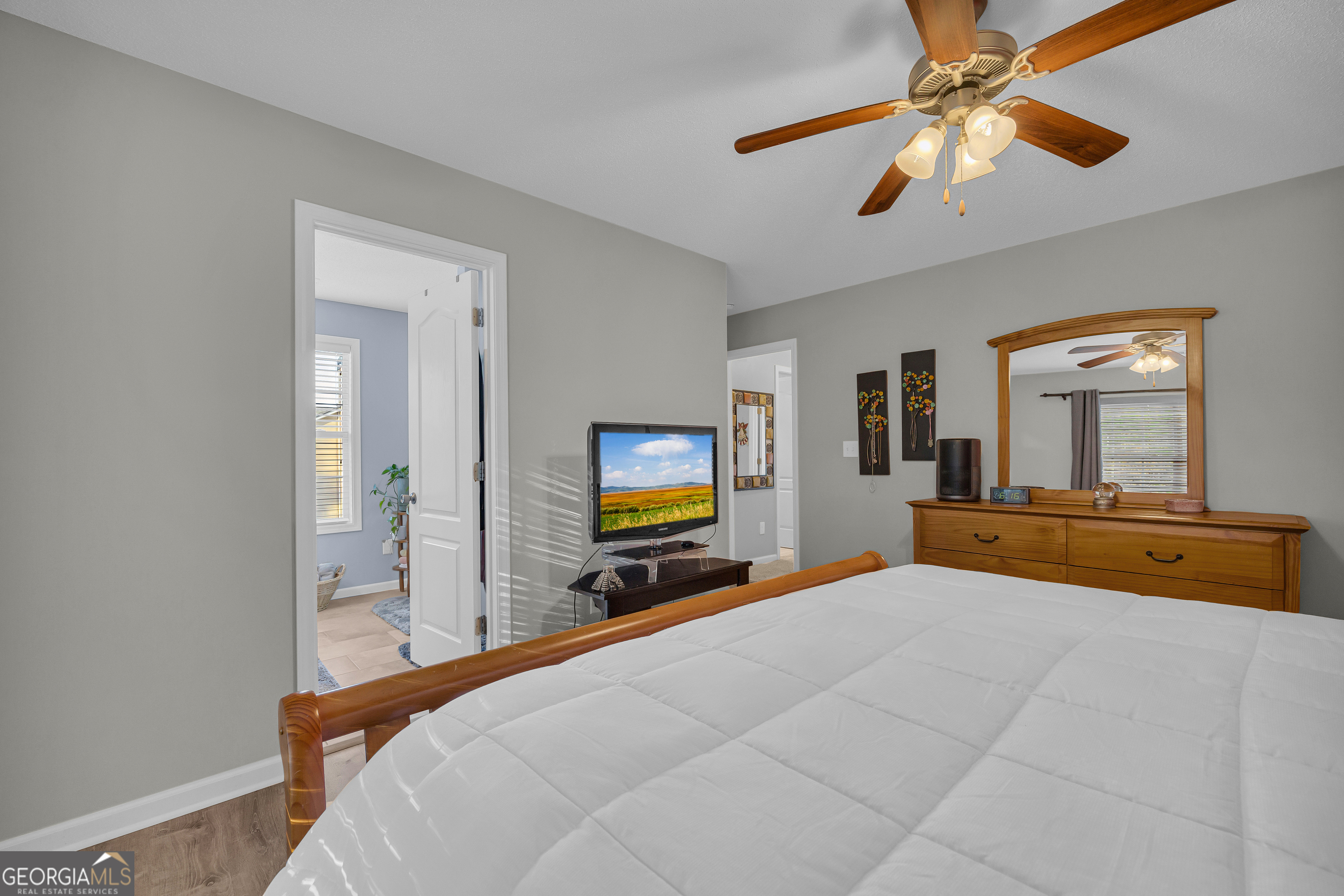 259 Watson Drive Hull, GA 30646 - Photo 38 of 47 a bedroom with a large bed and a chandelier