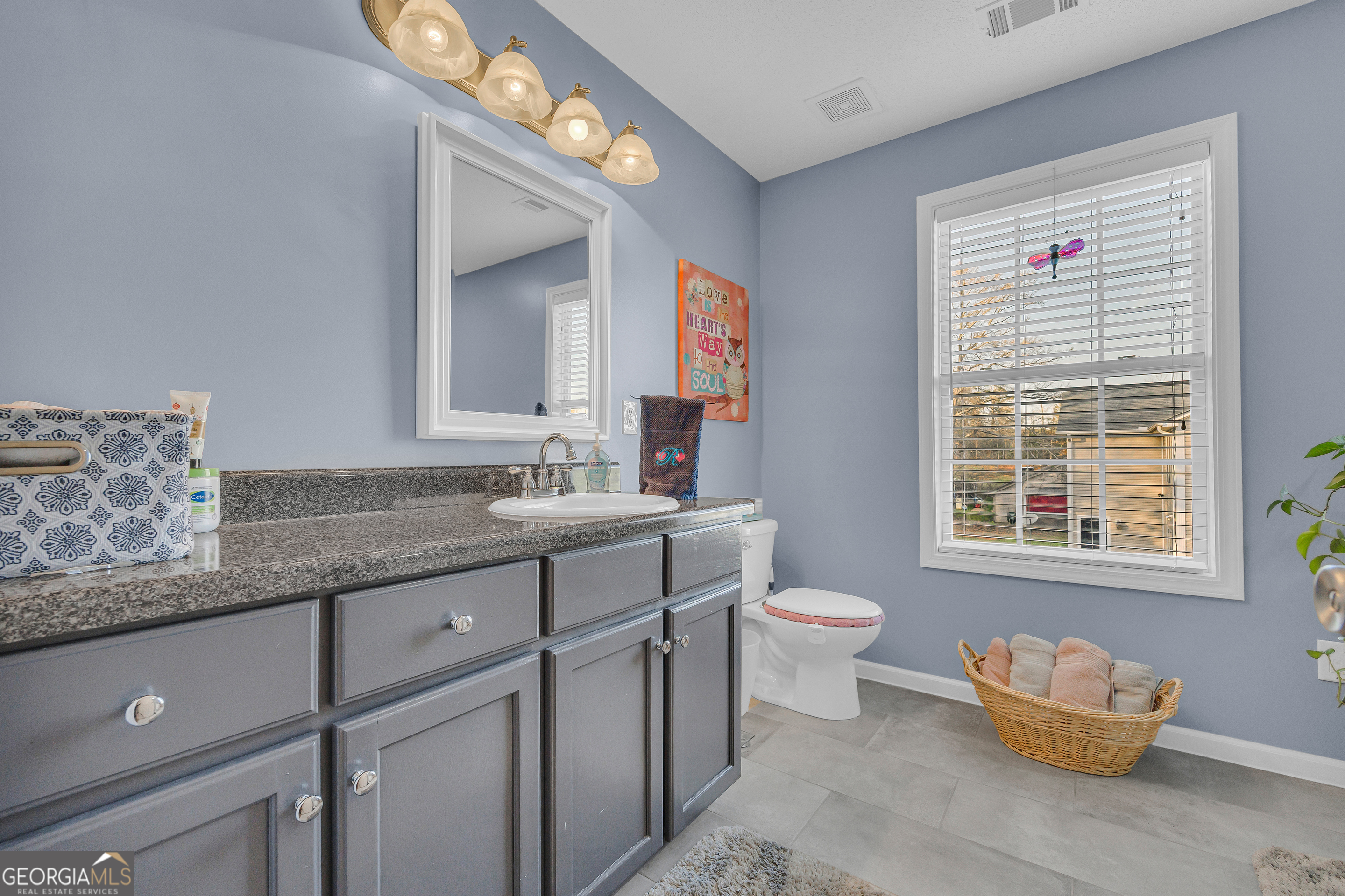259 Watson Drive Hull, GA 30646 - Photo 40 of 47 a bathroom with a granite countertop sink mirror vanity and a toilet