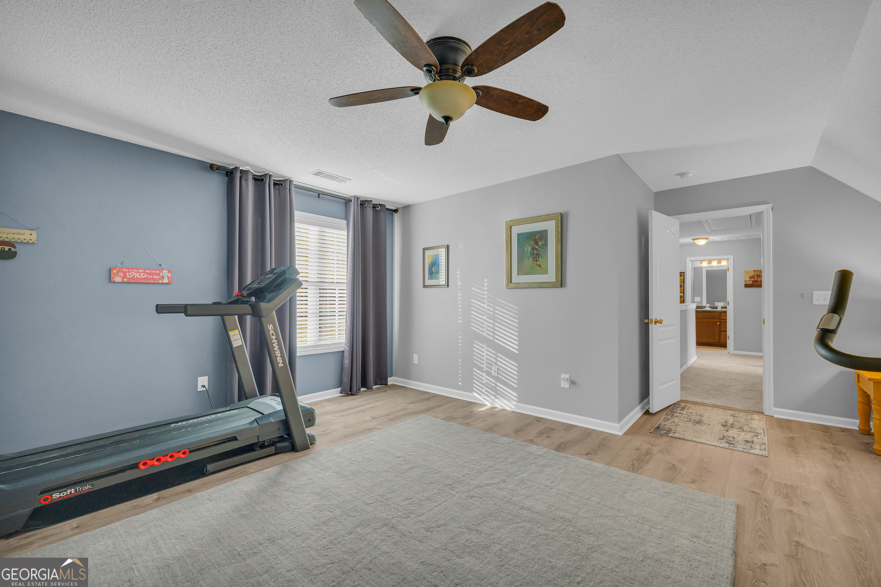 259 Watson Drive Hull, GA 30646 - Photo 45 of 47 a view of a room with gym equipment and a chandelier fan