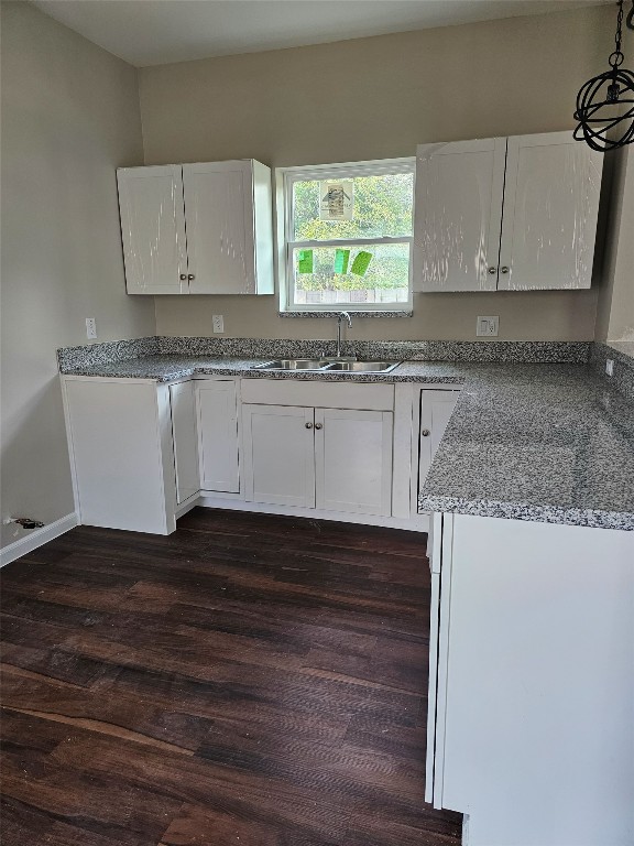 9730 Kerr Street Houston, TX 77029 - Photo 4 of 9 a kitchen with granite countertop white cabinets white appliances a sink and a window