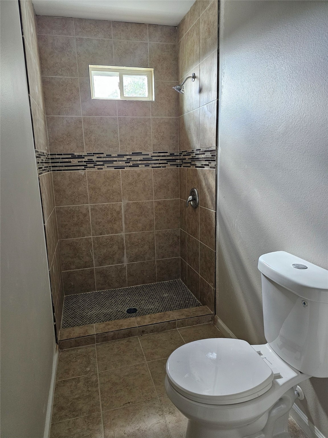 9730 Kerr Street Houston, TX 77029 - Photo 6 of 9 a bathroom with a toilet and a shower