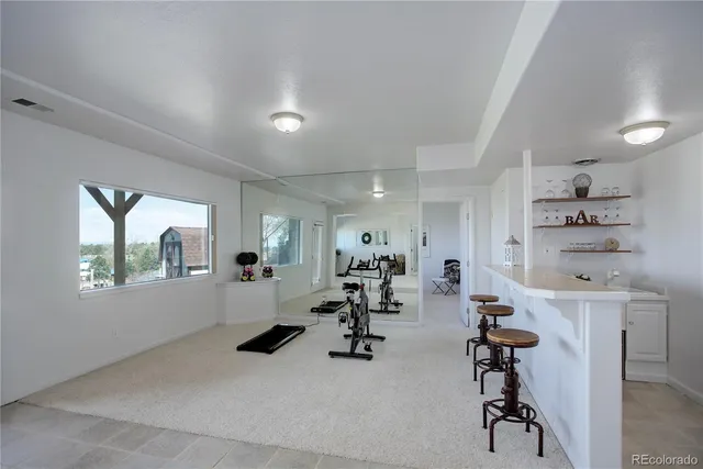 a kitchen with a cabinets and a stove with wooden floor