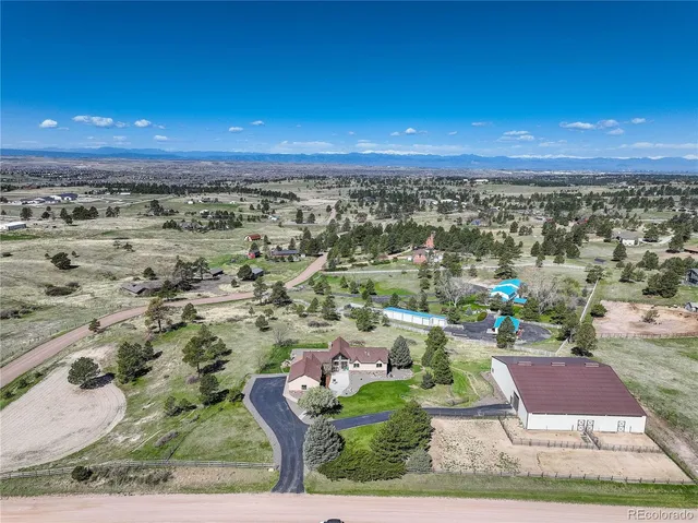 an aerial view of multiple houses with a yard