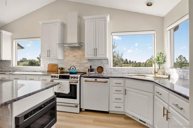 a kitchen with white cabinets and white appliances