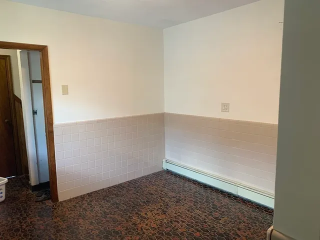 a kitchen with a refrigerator and a stove