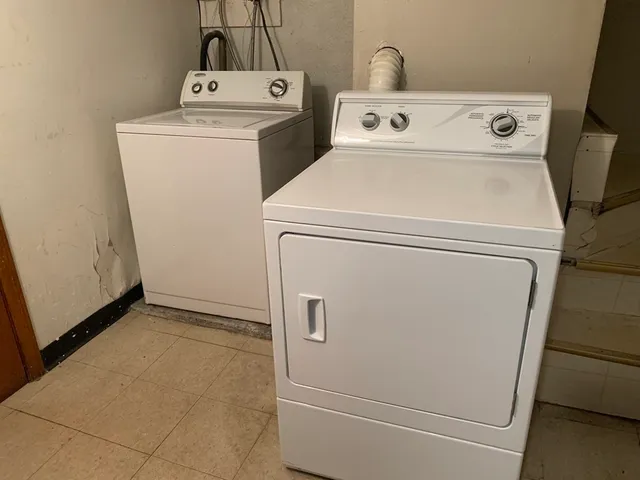 a view of a patio with table and chairs with wooden floor and plants