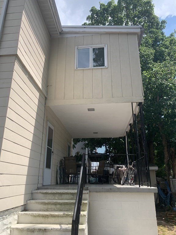 52 Winter Street, Unit 2 Medford, MA 02155 - Photo 14 of 15 a view of a patio with table and chairs with wooden floor and plants