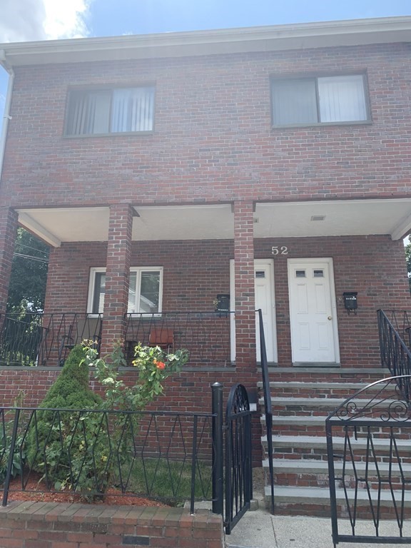 52 Winter Street, Unit 2 Medford, MA 02155 - Photo 2 of 15 a front view of a house with a garden