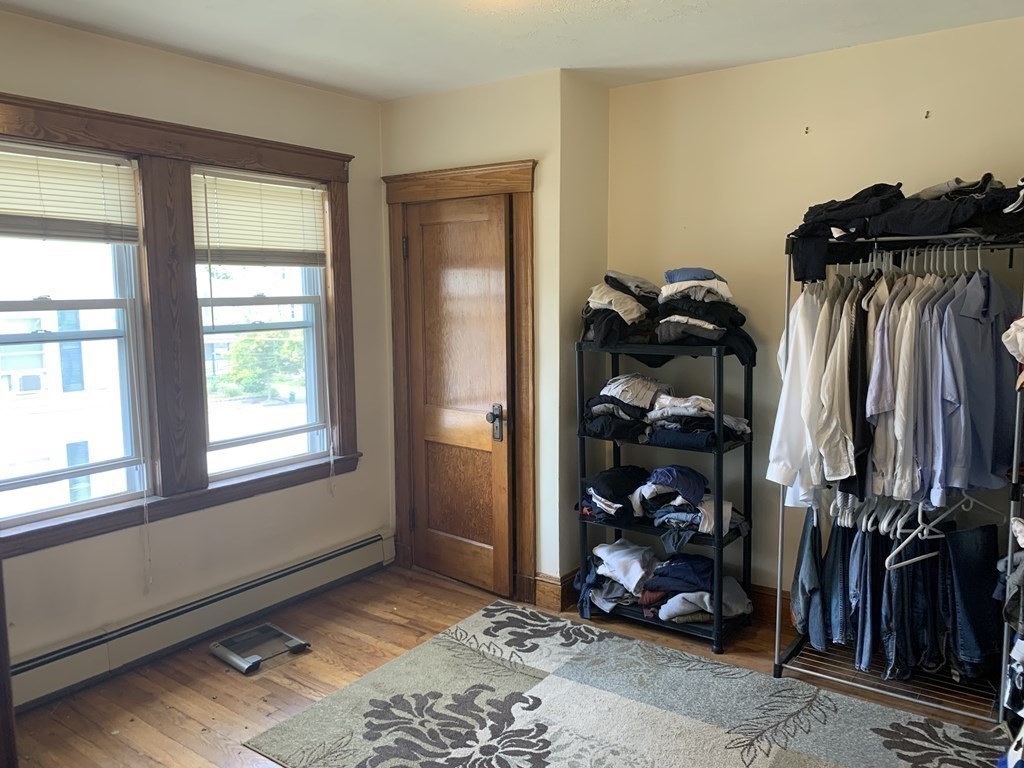 52 Winter Street, Unit 2 Medford, MA 02155 - Photo 7 of 15 a view of walk in closet with clothes and shoes