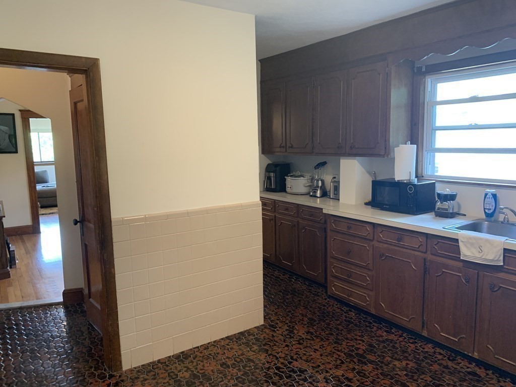 52 Winter Street, Unit 2 Medford, MA 02155 - Photo 8 of 15 a kitchen with sink a window and cabinets