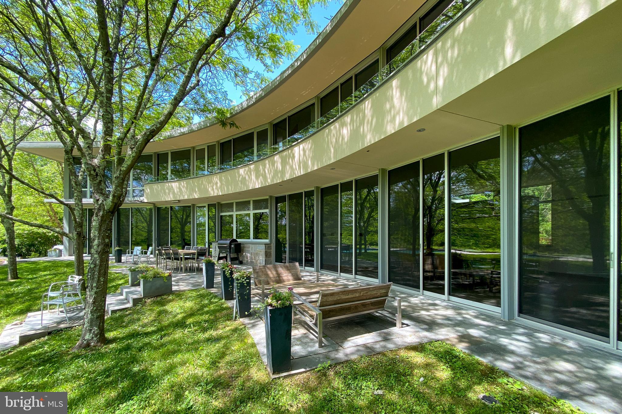 4750 Province Line Road Princeton, NJ 08540 - Photo 40 of 50 a view of a patio with table and chairs potted plants and large tree