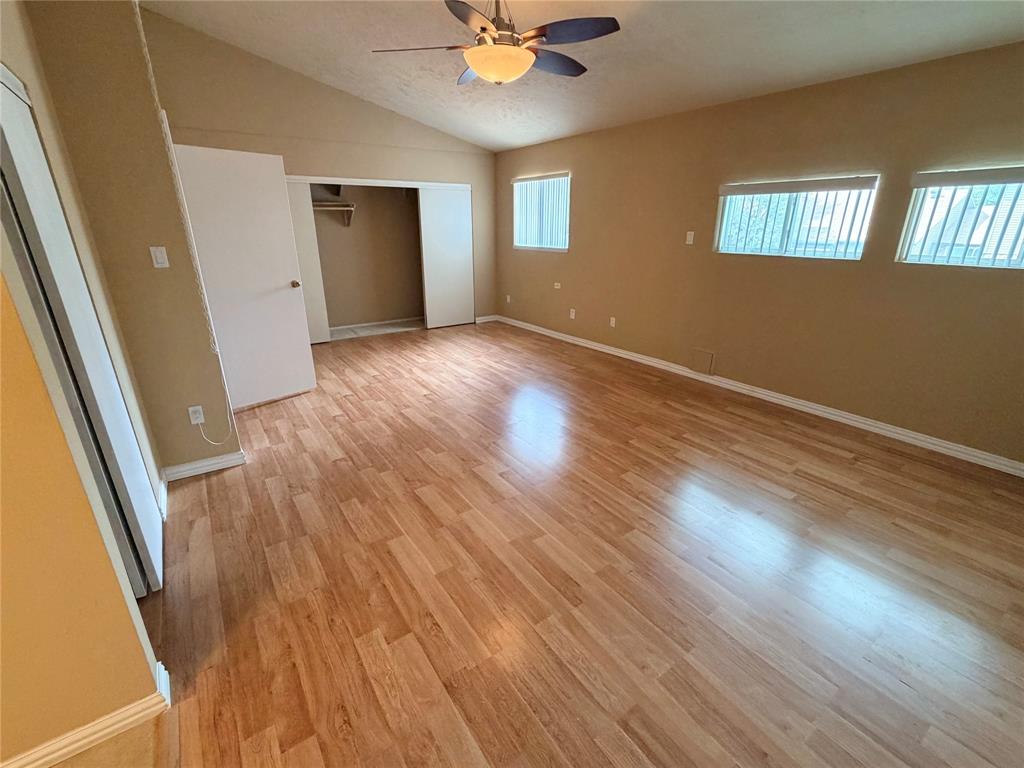 2051 Embassy Way Carrollton, TX 75006 - Photo 13 of 20 Unfurnished bedroom with light wood-type flooring, vaulted ceiling, a closet, and a ceiling fan