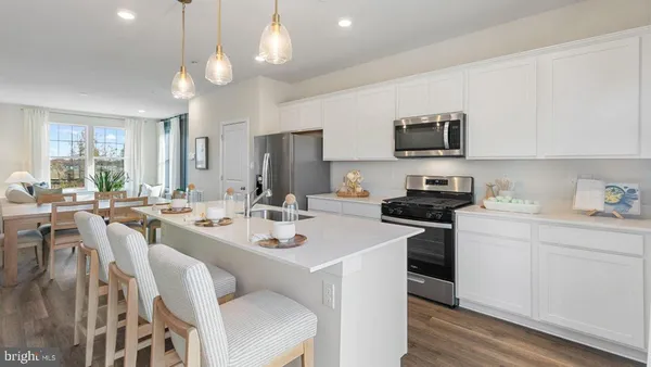 a kitchen with a sink stove and microwave