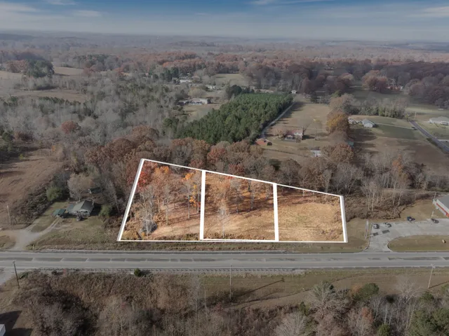 a view of a houses with a road