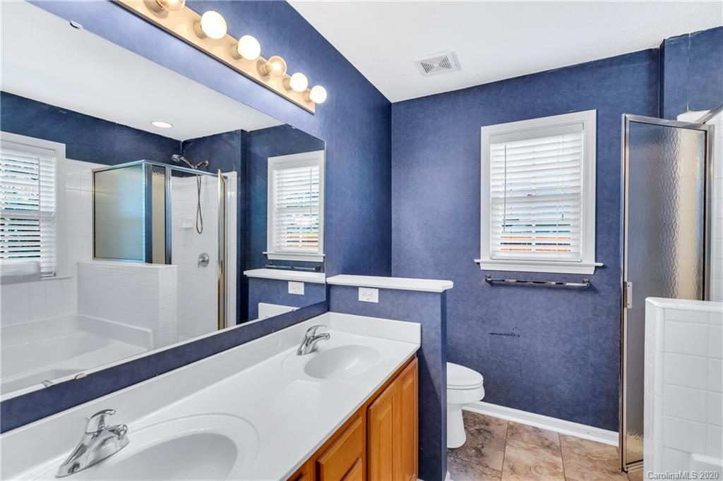 10 Farm Valley Road Fletcher, NC 28732 - Photo 19 of 29 a bathroom with a sink a toilet and a large mirror
