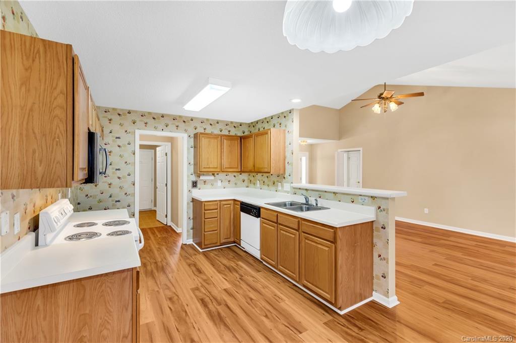 10 Farm Valley Road Fletcher, NC 28732 - Photo 22 of 29 a kitchen with a stove a sink and a refrigerator