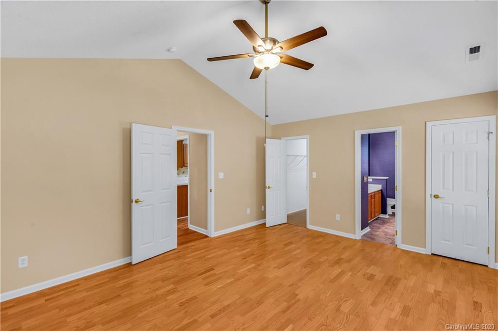 10 Farm Valley Road Fletcher, NC 28732 - Photo 29 of 29 a bedroom with a bed and a chandelier