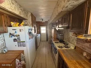 a kitchen with stainless steel appliances granite countertop a stove a sink dishwasher and refrigerator