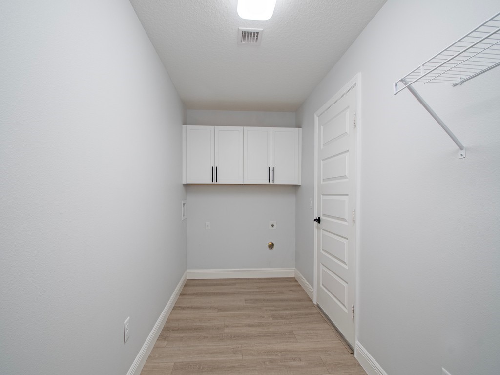 431 Midvale Terrace Sebastian, FL 32958 - Photo 26 of 34 a view of a room with wooden floor and white walls