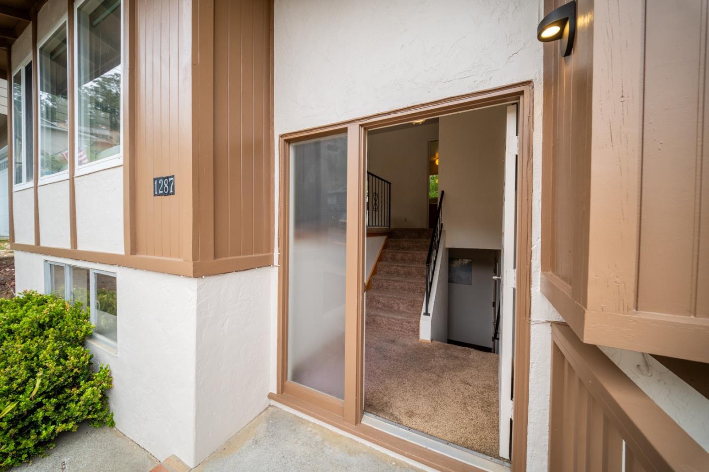 1287 Lerida Way Pacifica, CA 94044 - Photo 6 of 52 a view of a hallway with wooden floor and a living room
