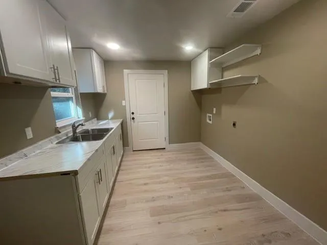 a kitchen with a sink and refrigerator