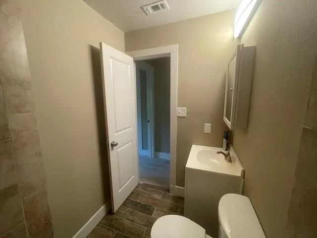a bathroom with a sink mirror toilet and bathtub