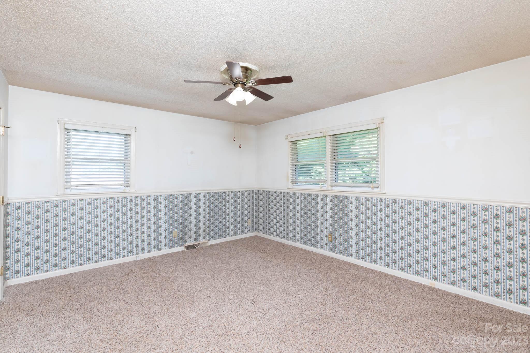 480 Plantation Road Rock Hill, SC 29732 - Photo 14 of 31 a view of a livingroom with a chandelier fan and windows