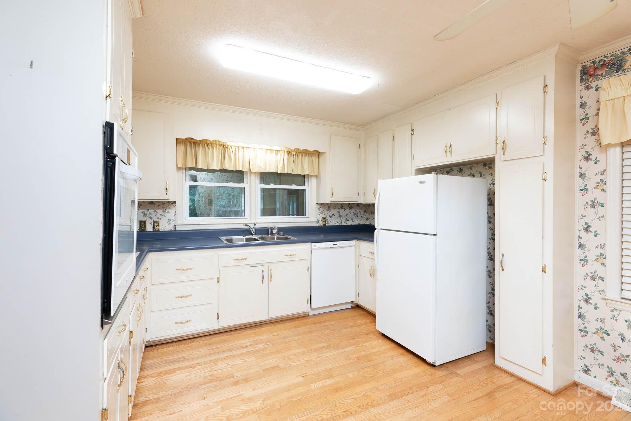 480 Plantation Road Rock Hill, SC 29732 - Photo 5 of 31 a kitchen with a refrigerator a stove top oven and white cabinets