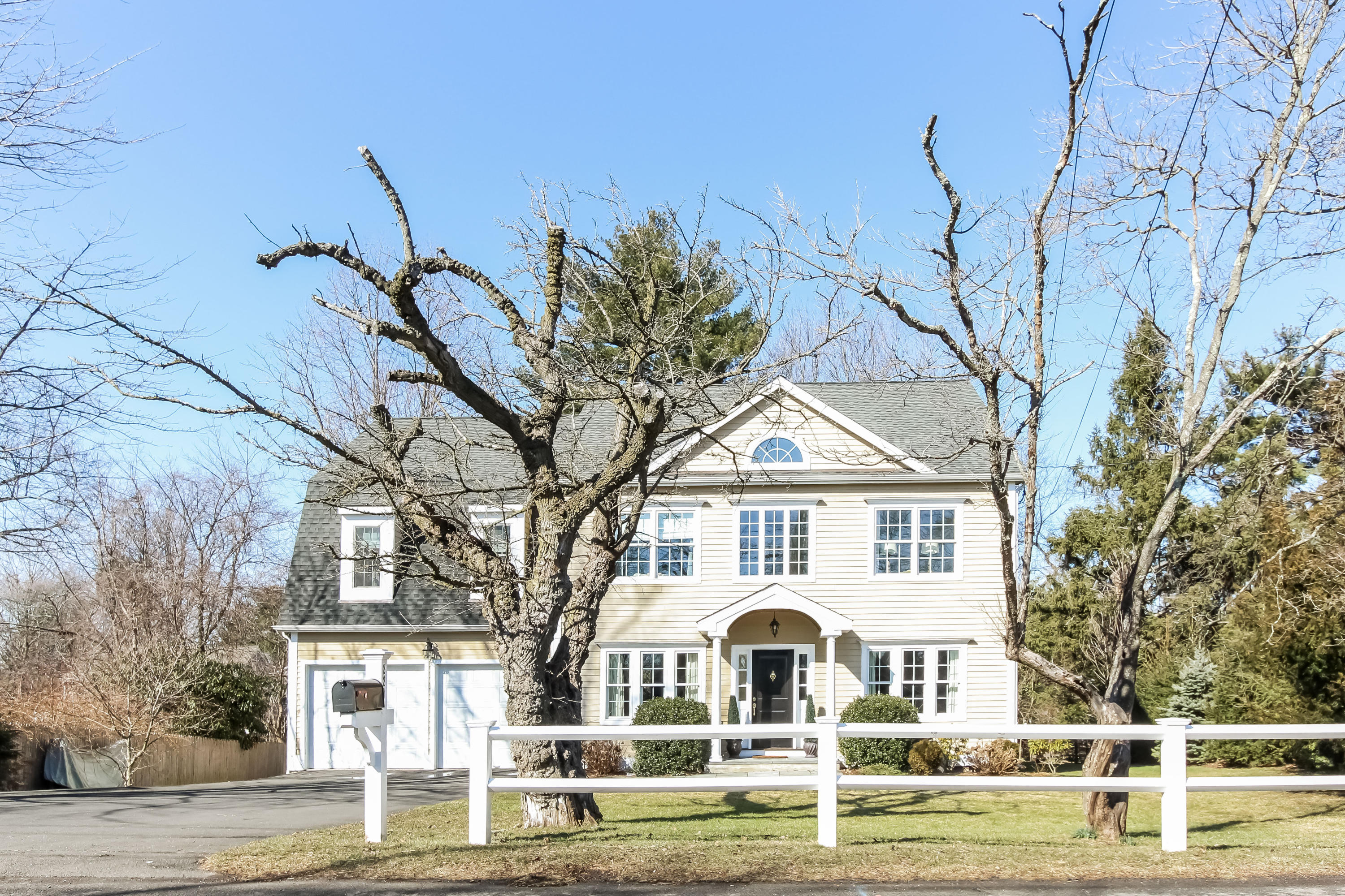 221 Hollow Tree Ridge Road Darien, CT 06820 - Photo 1 of 28 a view of a white house with a yard