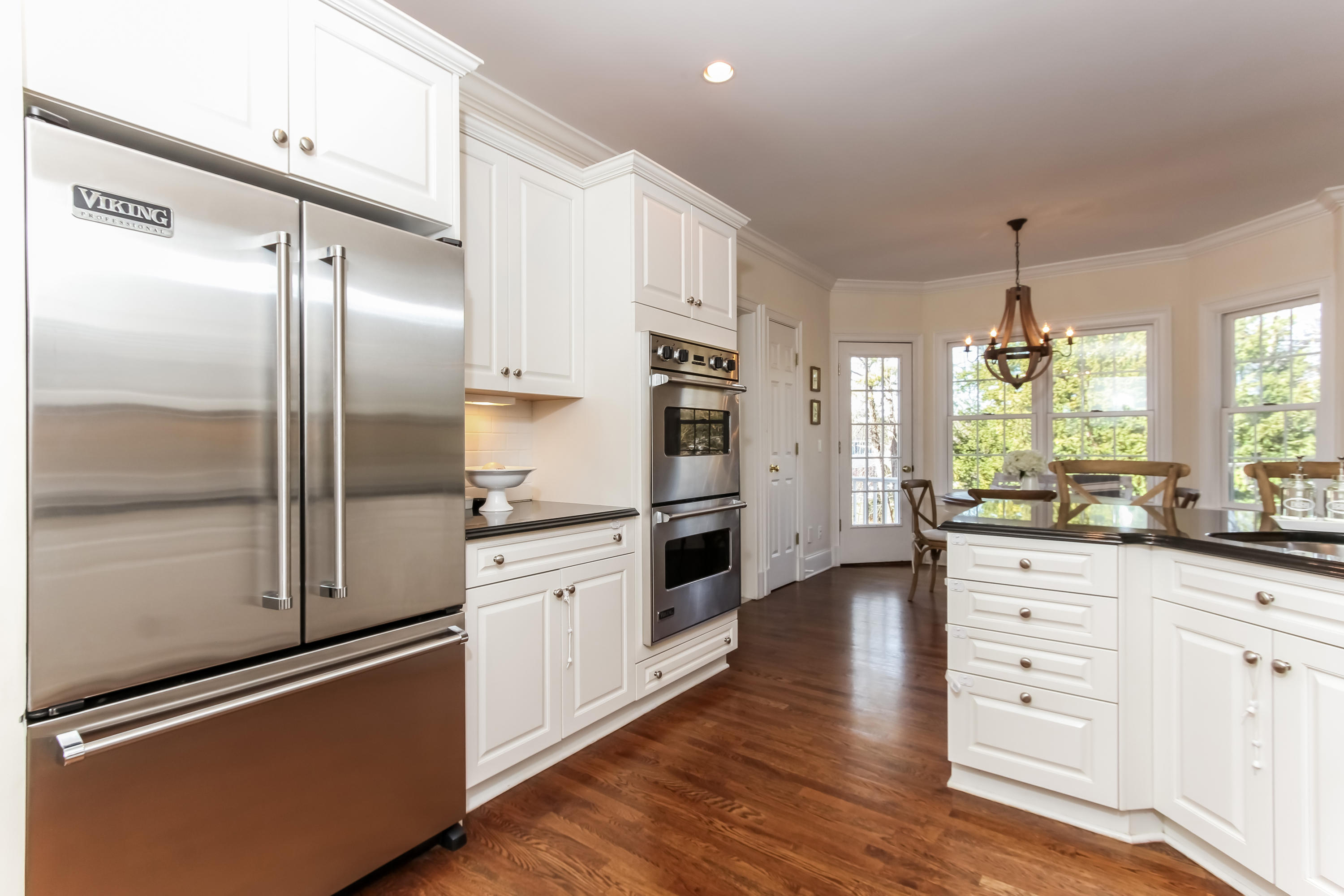 221 Hollow Tree Ridge Road Darien, CT 06820 - Photo 11 of 28 a kitchen with stainless steel appliances a refrigerator sink and cabinets