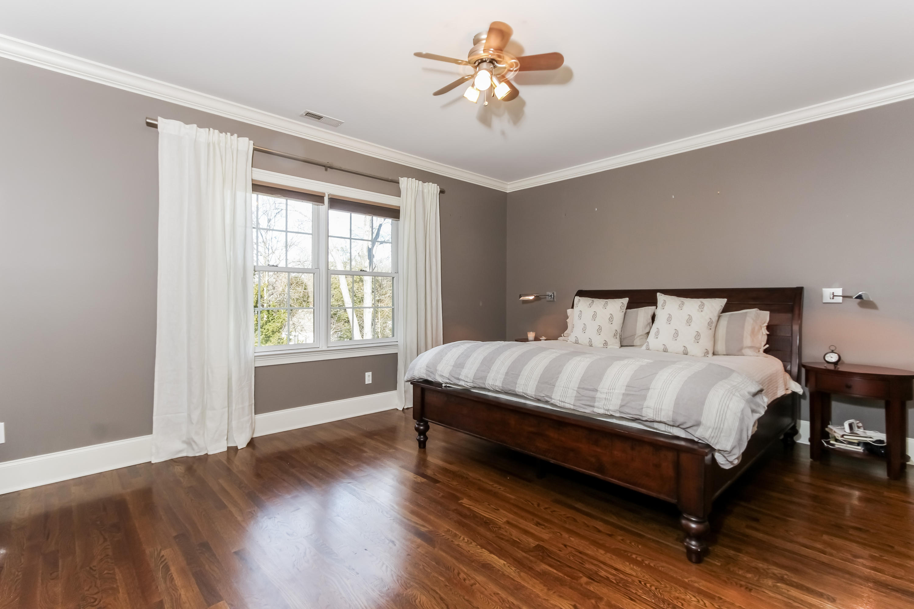 221 Hollow Tree Ridge Road Darien, CT 06820 - Photo 13 of 28 a bedroom with a bed and wooden floor