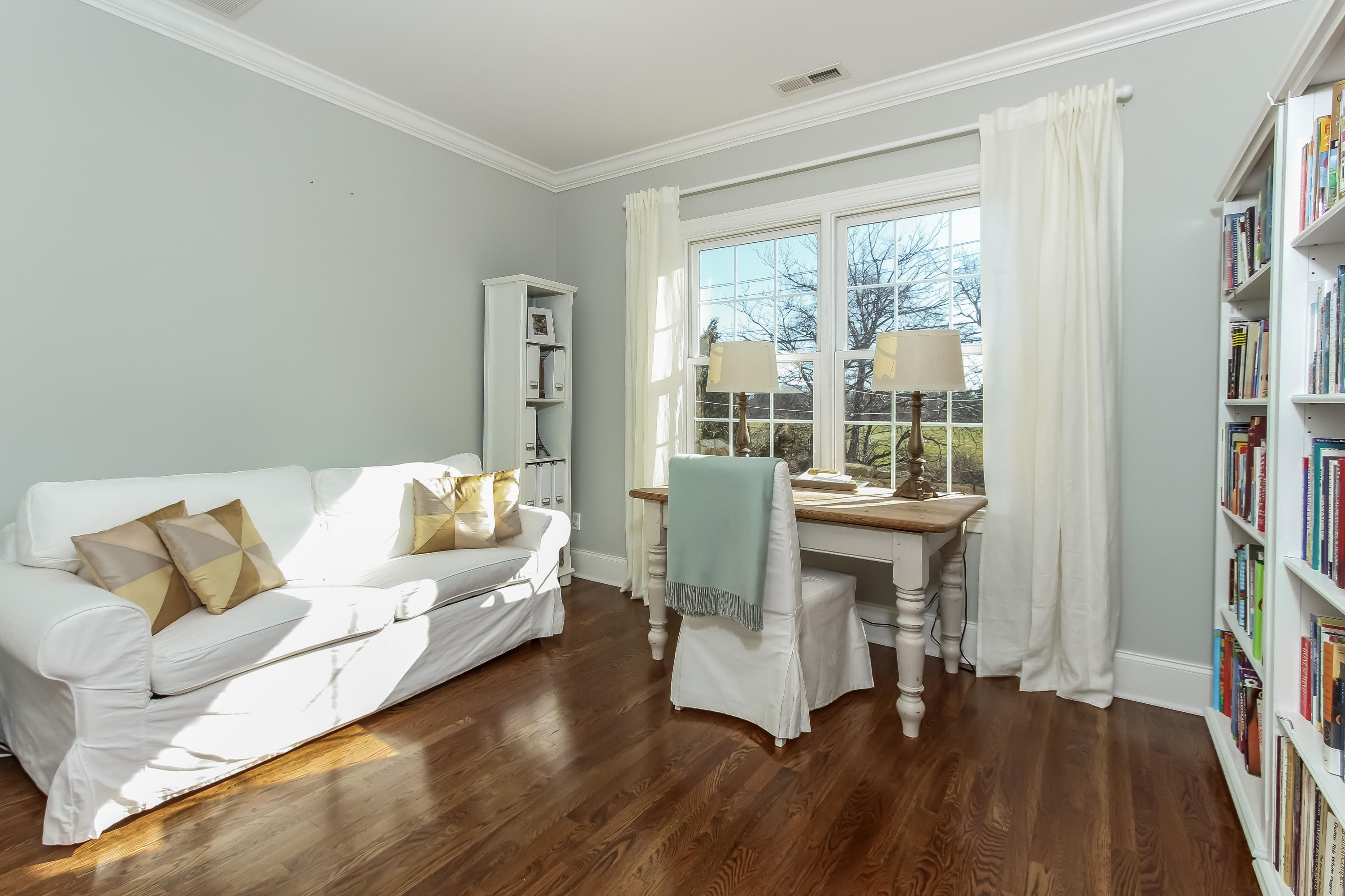 221 Hollow Tree Ridge Road Darien, CT 06820 - Photo 18 of 28 a living room with furniture and a floor to ceiling window