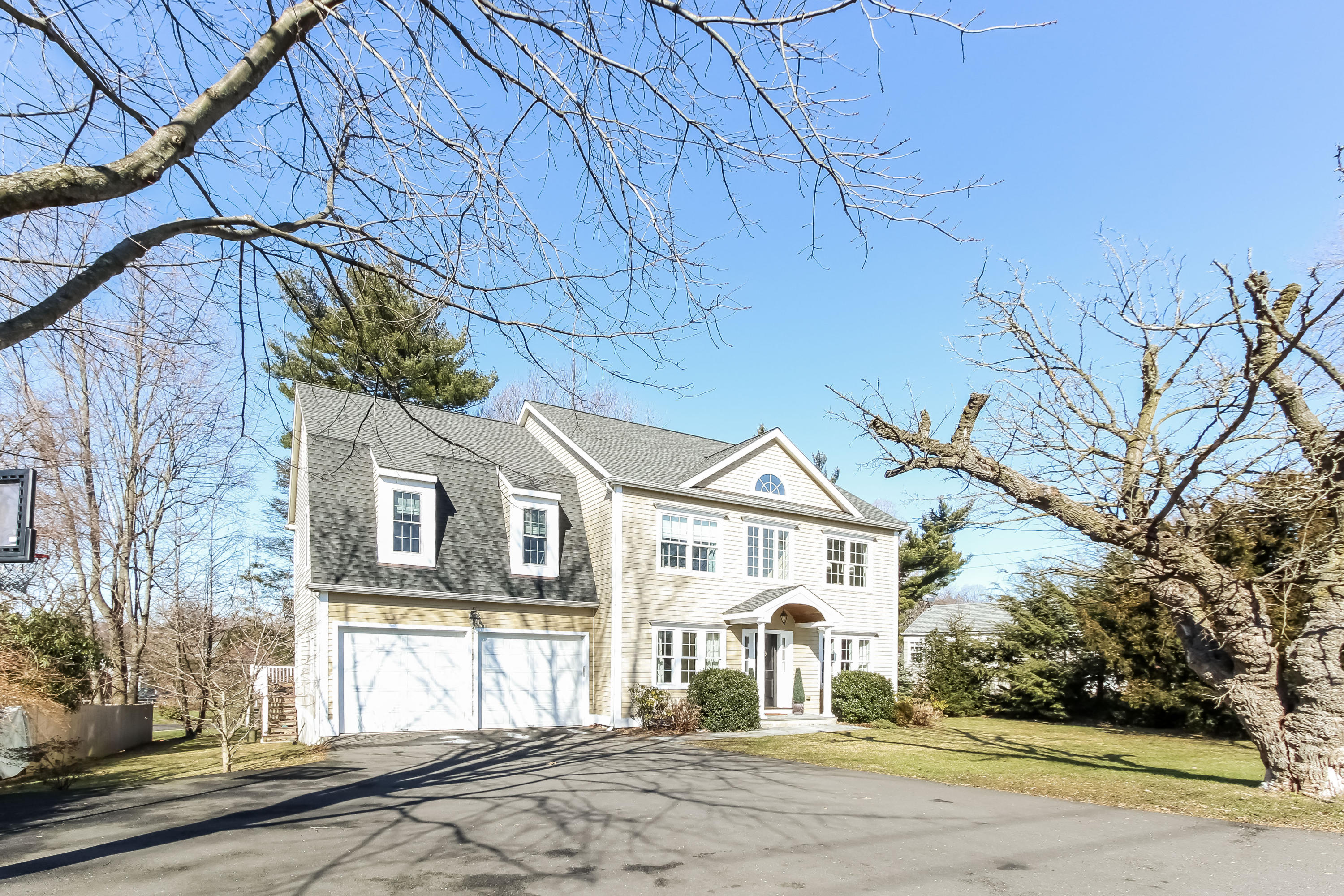 221 Hollow Tree Ridge Road Darien, CT 06820 - Photo 2 of 28 a view of a white house with a road and windows