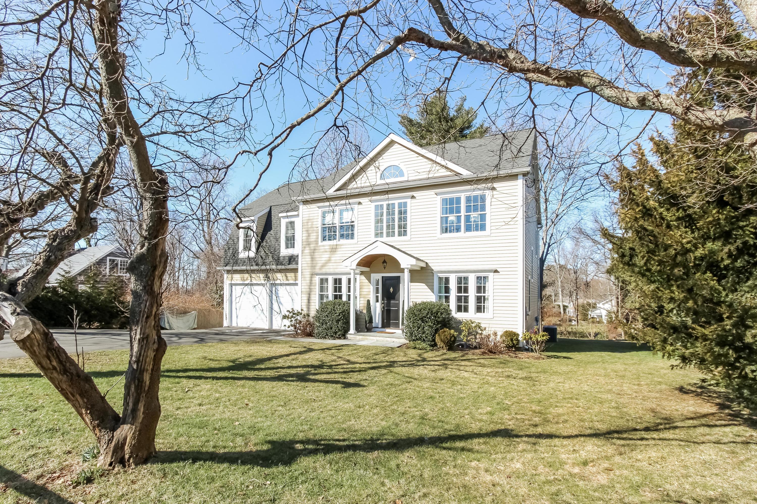 221 Hollow Tree Ridge Road Darien, CT 06820 - Photo 3 of 28 a front view of a house with a yard