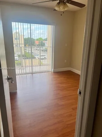 a view of an empty room and a window