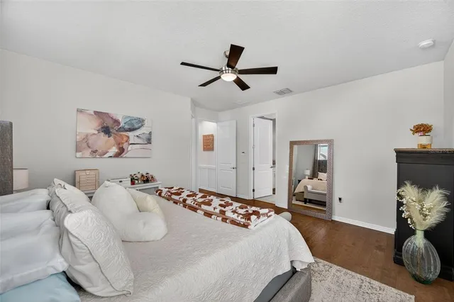 a kitchen with a stove a sink a kitchen island with chairs and wooden floor