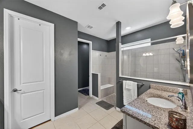a kitchen with granite countertop a sink a stove and cabinets