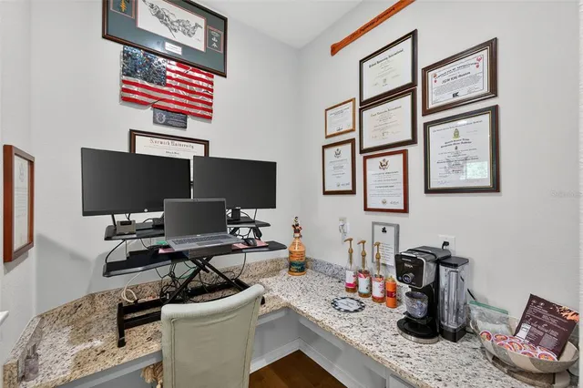 a living room with furniture and a flat screen tv with wooden floor