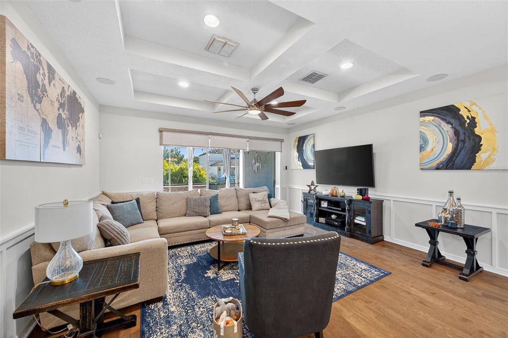5706 Esker Falls Lane Lithia, FL 33547 - Photo 31 of 76 a living room with furniture and a flat screen tv with wooden floor