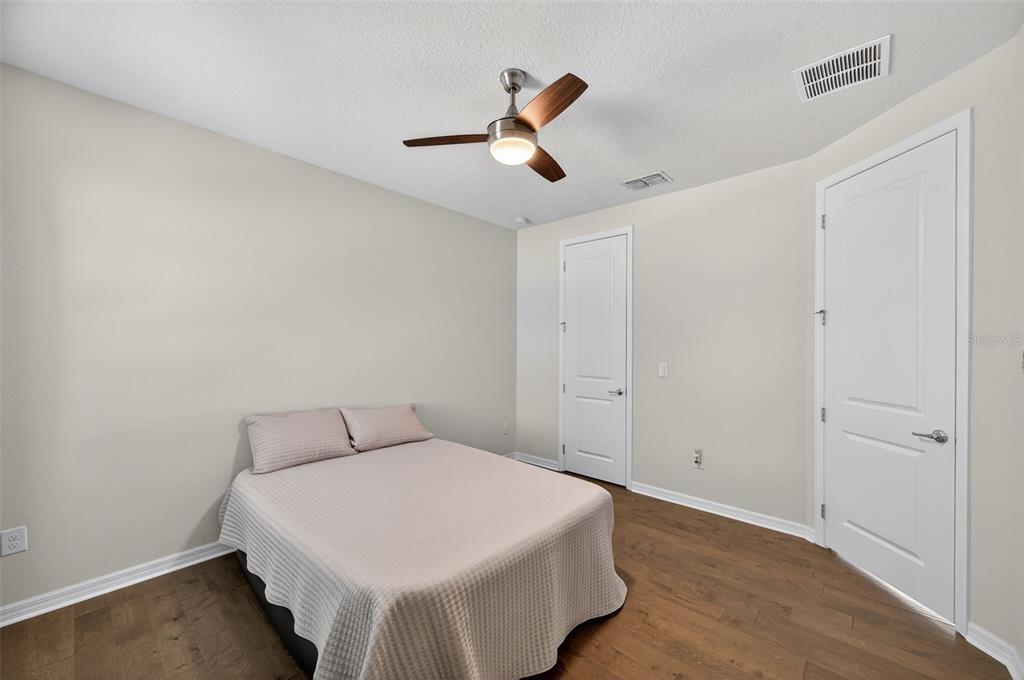 5706 Esker Falls Lane Lithia, FL 33547 - Photo 37 of 76 a bedroom with a bed and a ceiling fan