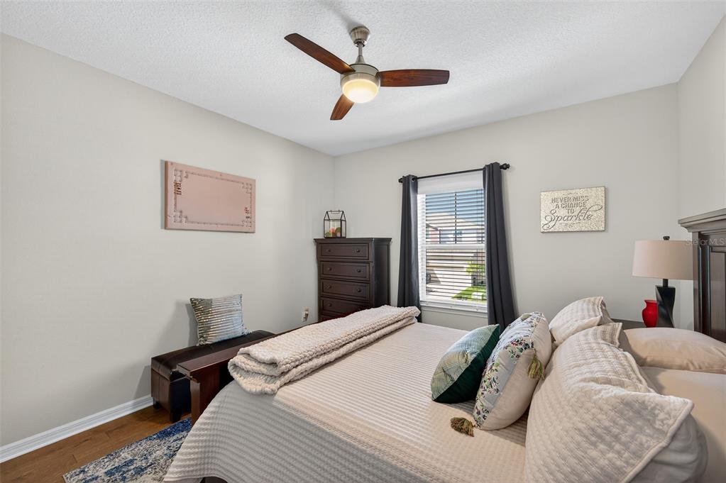 5706 Esker Falls Lane Lithia, FL 33547 - Photo 39 of 76 a bedroom with a bed and a lamp