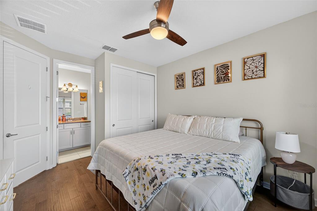 5706 Esker Falls Lane Lithia, FL 33547 - Photo 44 of 76 a bedroom with a large bed and a chandelier