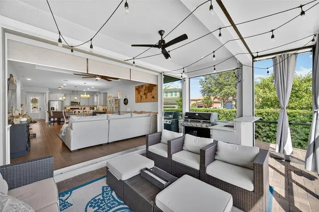 a dining room with furniture a chandelier and wooden floor