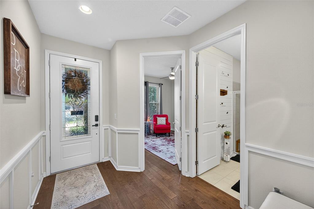 5706 Esker Falls Lane Lithia, FL 33547 - Photo 6 of 76 a view of an entryway with wooden floor and a livingroom view