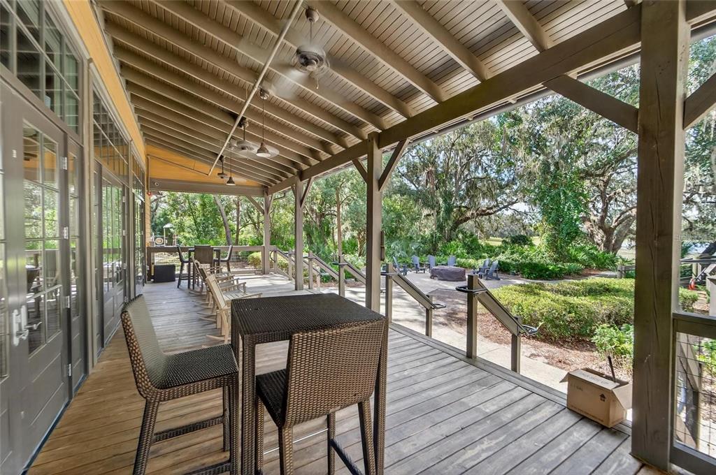 5706 Esker Falls Lane Lithia, FL 33547 - Photo 72 of 76 a view of a patio with table and chairs and wooden floor